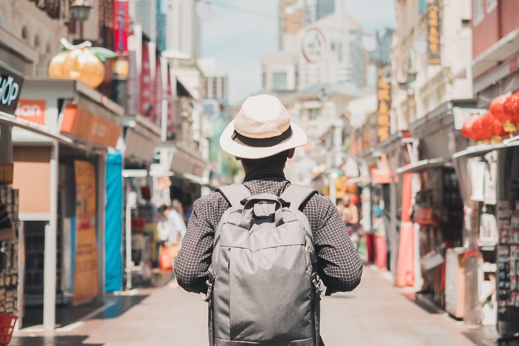 Young man traveling with backpack and hat